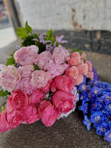 a mix of seasonal flowers in pink, lilac, purple and blue shades.