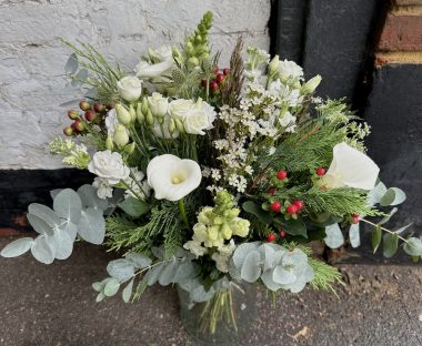 Winter Woodland in a vase next to a white wall.